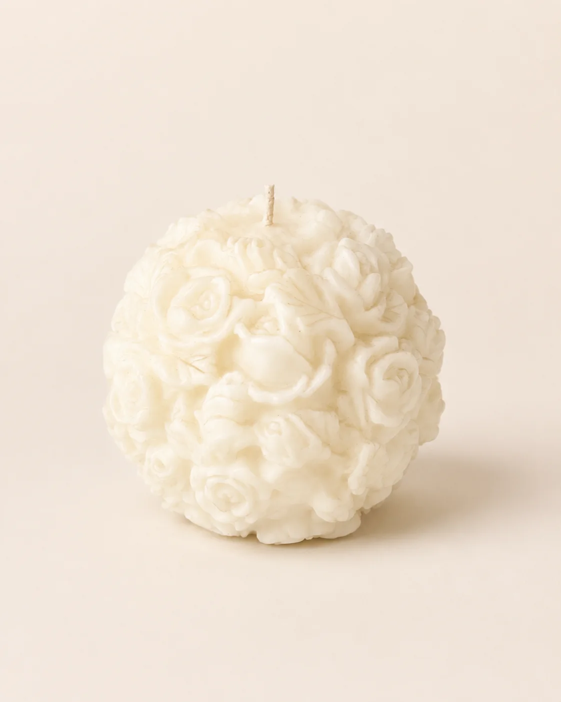 Candela Sfera Rose — sfera bianca con rose in rilievo su sfondo neutro